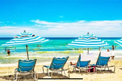 a group of chairs and umbrellas on a beach at Studio with 2 Full Beds, Your Beach Base in the City in Hallandale Beach