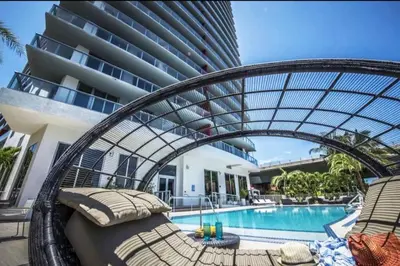 a resort with a swimming pool and a building at Studio with 2 Full Beds, Your Beach Base in the City in Hallandale Beach