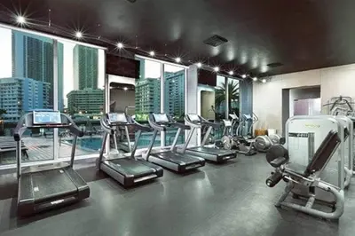 a gym with treadmills and ellipticals in a building at Studio with 2 Full Beds, Your Beach Base in the City in Hallandale Beach
