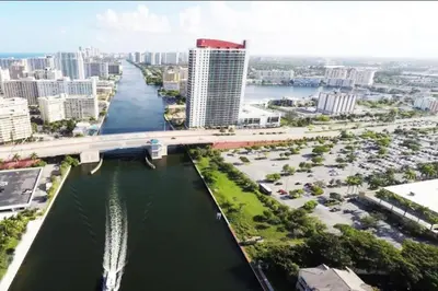 an aerial view of a city with a bridge over a river at Sunlit BeachWalk Studio, 2 Full Beds, Coastal Charm in Hallandale Beach