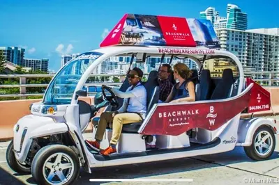 a group of people sitting in a golf cart at Beachy Vibes Studio, 2 Full Beds, Near Everything in Hallandale Beach