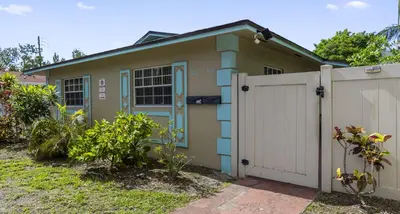 a house with a gate and a fence at Stylish 2BR Villa full kitchen 10 mins from Beach in Fort Lauderdale