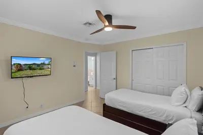 a bedroom with two beds and a ceiling fan at Stylish 2BR Villa full kitchen 10 mins from Beach in Fort Lauderdale