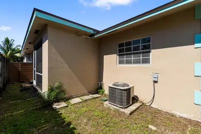a house with an air conditioner outside of it at Stylish 2BR Villa full kitchen 10 mins from Beach in Fort Lauderdale