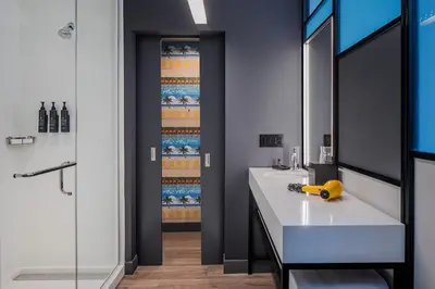 a bathroom with two sinks and a shower at Aloft Fort Lauderdale Airport & Cruise Port in Fort Lauderdale