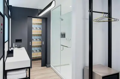 a bathroom with a shower and a sink at Aloft Fort Lauderdale Airport & Cruise Port in Fort Lauderdale