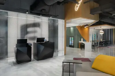 a lobby with a couch and a dining room at Aloft Fort Lauderdale Airport & Cruise Port in Fort Lauderdale
