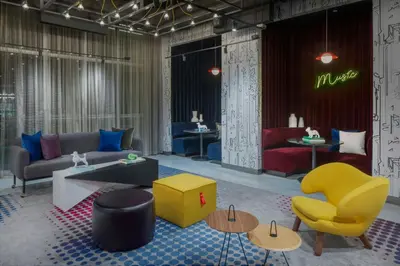 a lobby with a couch and chairs and tables at Aloft Fort Lauderdale Airport & Cruise Port in Fort Lauderdale