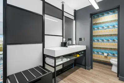 a bathroom with a sink and a toilet at Aloft Fort Lauderdale Airport & Cruise Port in Fort Lauderdale