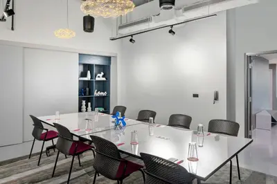 a meeting room with a white table and chairs at Aloft Fort Lauderdale Airport & Cruise Port in Fort Lauderdale