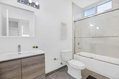 a bathroom with a toilet and a sink and a shower at Up to 12 Guests! Modern villa near Wynwood in Miami