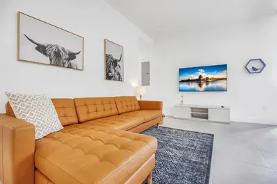 a living room with a couch and a tv at Up to 12 Guests! Modern villa near Wynwood in Miami