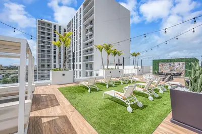 a patio with chairs and grass on a building at Modern Unit in Downtown Miami With Free Parking in Miami