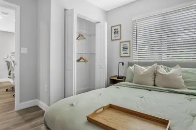 a bedroom with a bed with a wooden tray on it at Sistrunk Shades Villas #1 - Brand New Townhomes Downtown Fort Lauderdale in Fort Lauderdale
