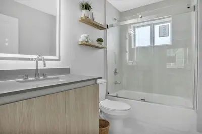 a bathroom with a toilet and a sink and a shower at Sistrunk Shades Villas #1 - Brand New Townhomes Downtown Fort Lauderdale in Fort Lauderdale