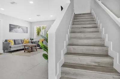 a staircase in a house with a living room at Sistrunk Shades Villas #2 New Downtown Fort Lauderdale Townhomes in Fort Lauderdale