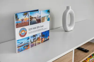 a sign for a vacation rental on a table next to a vase at Sistrunk Shades Villas #3 - Brand New Townhomes Downtown Fort Lauderdale in Fort Lauderdale