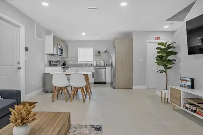 a kitchen and living room with a table and chairs at 30 Guests 3 Identical Brand New Townhomes in Downtown Fort Lauderdale in Fort Lauderdale
