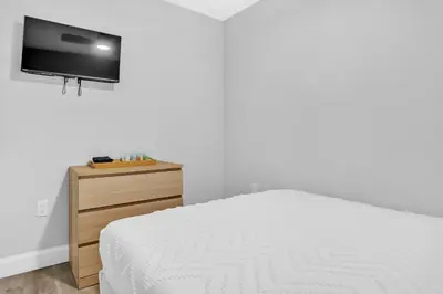 a bedroom with a bed and a tv on a wall at 30 Guests 3 Identical Brand New Townhomes in Downtown Fort Lauderdale in Fort Lauderdale