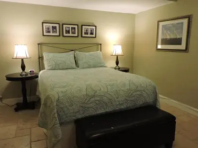 a bedroom with a bed with two lamps and two tables at 310 Oasis Paradise in Hollywood