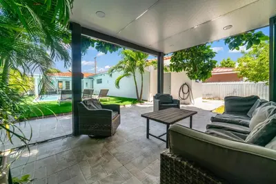a patio with two couches and a table at Luxury Vacation House in Miami’s Center! in Miami