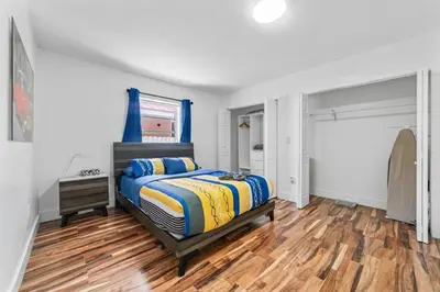 a bedroom with a bed and a wooden floor at Luxury Vacation House in Miami’s Center! in Miami