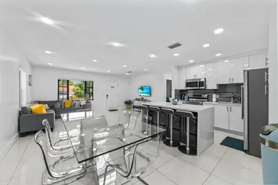 a kitchen and living room with a glass table at Luxury Vacation House in Miami’s Center! in Miami