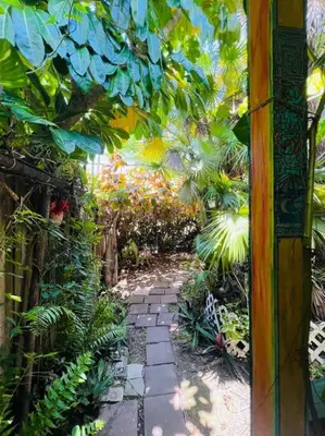 a garden with a walkway with plants and trees at Miami Bungalow Oasis near Everglades & The Keys in Cutler Bay