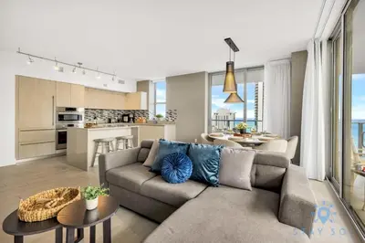 a living room with a couch and a kitchen at Wrap Around Balcony Insane Views Amazing Pools in Hollywood