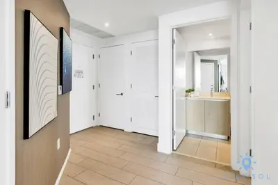 a hallway with a bathroom with a sink and a mirror at Wrap Around Balcony Insane Views Amazing Pools in Hollywood