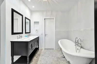 a white bathroom with a tub and a sink at Wonderful 4BR and 3BA Villa Heated Pool near Beach in Hollywood