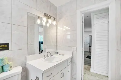 a white bathroom with a sink and a mirror at Luxury Villa with Heated Pool close to Beach in Hollywood