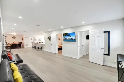 a living room with a couch and a dining room at Luxury Villa with Heated Pool close to Beach in Hollywood
