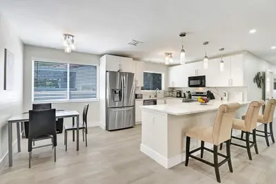 a kitchen and dining room with a table and chairs at Luxury Villa with Heated Pool close to Beach in Hollywood