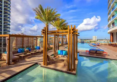 a pool on the roof of a building with a resort at Insane Ocean View Balcony Beachfront Condo Pool in Hollywood