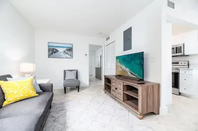 a living room with a couch and a flat screen tv at Heart Of Wilton 1 Recently Remodeled in Fort Lauderdale