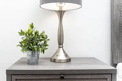 a table with a lamp and a potted plant on it at Heart of Wilton 3 Recently Remodeled in Fort Lauderdale
