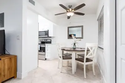 a dining room with a table and a ceiling fan at Heart of Wilton 3 Recently Remodeled in Fort Lauderdale