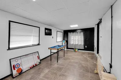 a room with a ping pong table in a room at Heated Pool Tropical Backyard 3 Bedrooms, 12 min to the Ocean in North Miami Beach