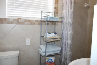 a bathroom with a towel rack next to a toilet at Stunning suite by hard rock stadium and casino in Miami