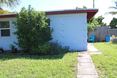 a house with a blue garage in the yard at Stunning suite by hard rock stadium and casino in Miami