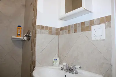 a bathroom with a sink and a mirror at Stunning suite by hard rock stadium and casino in Miami