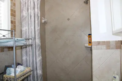 a shower with a shower curtain in a bathroom at Stunning suite by hard rock stadium and casino in Miami