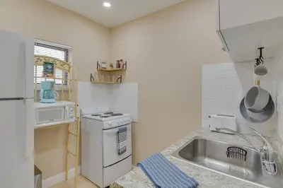 a kitchen with a sink and a stove top oven at Refreshing Miami Apartment 4 Mi to the Beach! in Miami