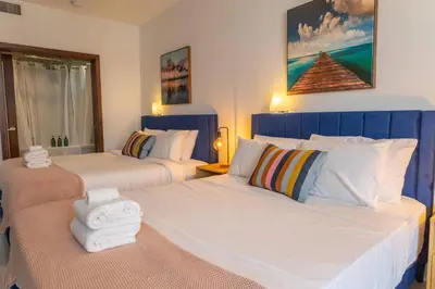a bedroom with two beds with towels on them at King bed Rooftop Suite Ocean Dr C304 in Miami Beach