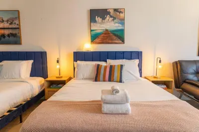 a bedroom with a large bed with a blue headboard at King bed Rooftop Suite Ocean Dr C304 in Miami Beach