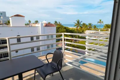 a balcony with a table and a view of the ocean at 1 Bedroom with King Bed and Roof-Top Pool and Bar C503 in Miami Beach