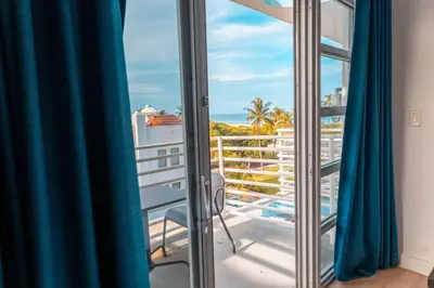 a room with a balcony with a view of the ocean at 1 Bedroom with King Bed and Roof-Top Pool and Bar C503 in Miami Beach