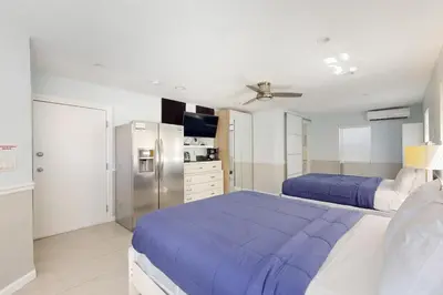 a bedroom with two beds and a refrigerator at Hollywood Bungalow in Hollywood
