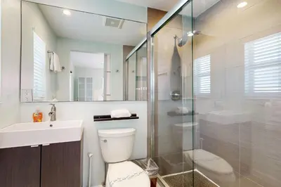 a bathroom with a toilet and a glass shower at Hollywood Bungalow in Hollywood